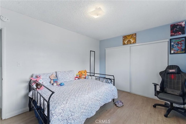 1089 E Columbia Ave, Pomona, CA 91767 - bedroom featuring wood finished floors, a textured ceiling, and a closet