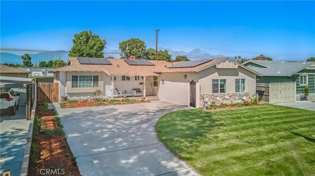 1089 E Columbia Ave, Pomona, CA 91767 - ranch-style home featuring a gate, stucco siding, roof mounted solar panels, and concrete driveway