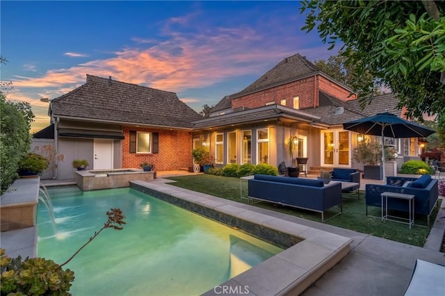 4275 Country Club Dr, Long Beach, CA 90807 - pool at dusk with an outdoor living space, a patio, french doors, and a pool with connected hot tub
