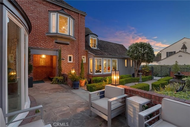 4275 Country Club Dr, Long Beach, CA 90807 - back of house at dusk with brick siding and a patio area