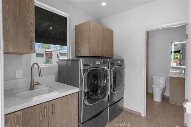 4275 Country Club Dr, Long Beach, CA 90807 - washroom with cabinet space, washer and dryer, healthy amount of natural light, and baseboards