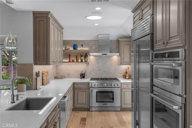 4275 Country Club Dr, Long Beach, CA 90807 - kitchen with premium appliances, wall chimney exhaust hood, a sink, light countertops, and recessed lighting