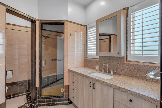 4275 Country Club Dr, Long Beach, CA 90807 - bathroom with a stall shower, vanity, backsplash, and tile walls