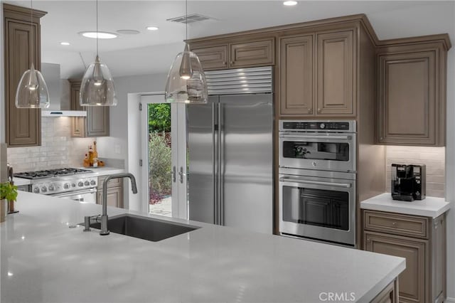 4275 Country Club Dr, Long Beach, CA 90807 - kitchen with premium appliances, a sink, light countertops, tasteful backsplash, and wall chimney range hood
