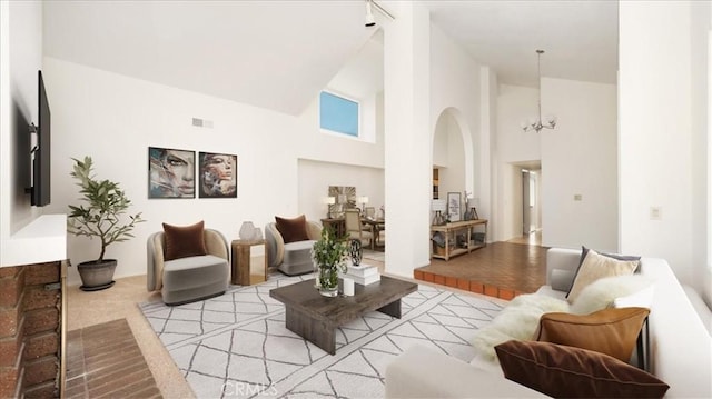 1589 Palomino Ave, Upland, CA 91786 - living room featuring high vaulted ceiling, arched walkways, light carpet, and a chandelier