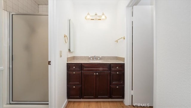 1589 Palomino Ave, Upland, CA 91786 - bathroom with a stall shower, vanity, wood finished floors, and baseboards