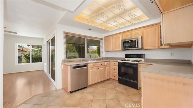 1589 Palomino Ave, Upland, CA 91786 - kitchen with stainless steel appliances, light brown cabinetry, plenty of natural light, and light tile patterned floors