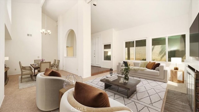 1589 Palomino Ave, Upland, CA 91786 - living area with a chandelier, high vaulted ceiling, light colored carpet, and baseboards