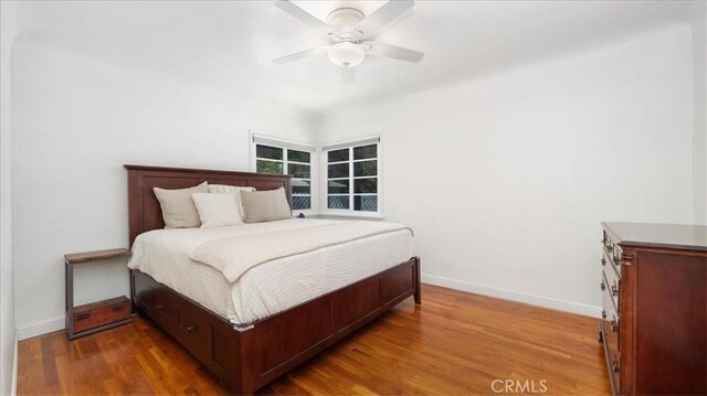 686 W 34th St, San Bernardino, CA 92405 - bedroom featuring baseboards, wood finished floors, and ceiling fan