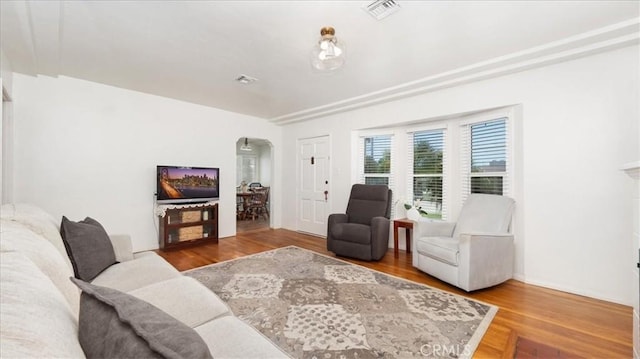 686 W 34th St, San Bernardino, CA 92405 - living area with arched walkways and wood finished floors