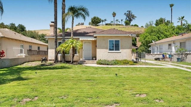 686 W 34th St, San Bernardino, CA 92405 - view of front of home with stucco siding and a chimney