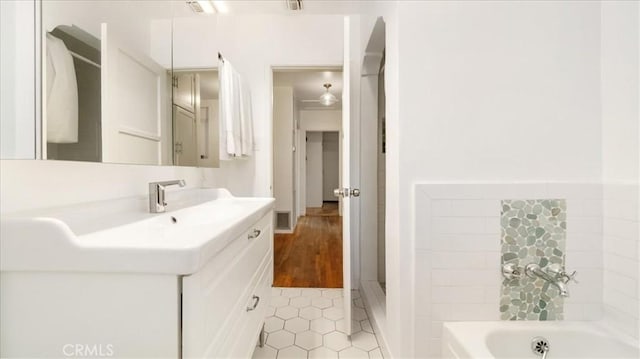 686 W 34th St, San Bernardino, CA 92405 - full bath featuring vanity, a garden tub, and tile patterned floors