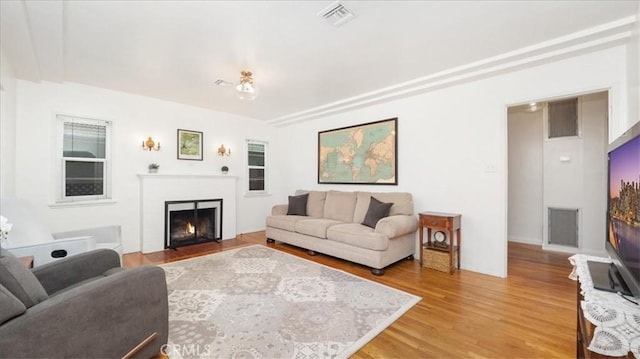 686 W 34th St, San Bernardino, CA 92405 - living area featuring a fireplace with flush hearth and light wood-style flooring