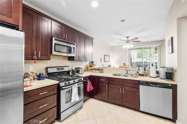 1441 Brett Pl Unit 136, San Pedro, CA 90732 - kitchen with stainless steel appliances, a sink, light countertops, light tile patterned flooring, and ceiling fan