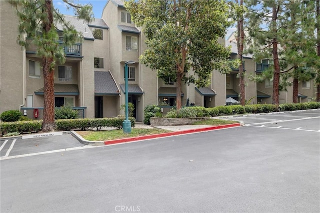 1441 Brett Pl Unit 136, San Pedro, CA 90732 - view of building exterior featuring uncovered parking and a residential view