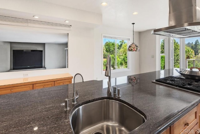 14040 Old Station Rd, San Diego, CA 92064 - kitchen with wall chimney range hood, a sink, brown cabinets, recessed lighting, and dark stone countertops