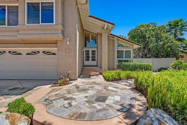 14040 Old Station Rd, San Diego, CA 92064 - doorway to property featuring stucco siding, a garage, french doors, and concrete driveway