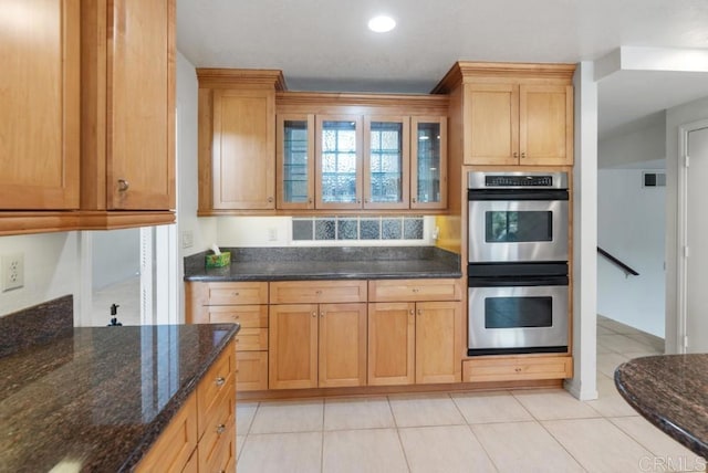 14040 Old Station Rd, San Diego, CA 92064 - kitchen with stainless steel double oven, glass insert cabinets, dark stone countertops, light tile patterned flooring, and recessed lighting