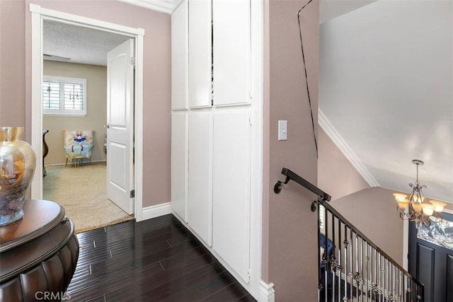 1725 Trinity Loop, Ontario, CA 91764 - hallway featuring an upstairs landing, dark wood finished floors, baseboards, a chandelier, and crown molding