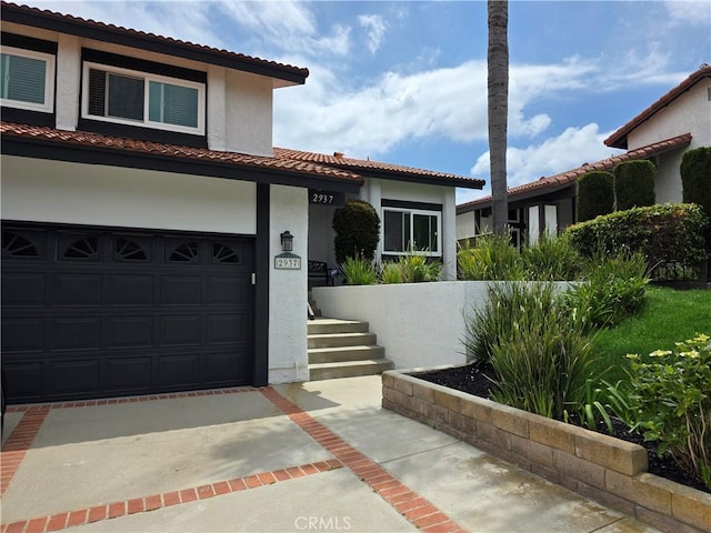 2937 Oakwood Ln, Torrance, CA 90505 - mediterranean / spanish-style home with concrete driveway, stucco siding, a tile roof, and an attached garage