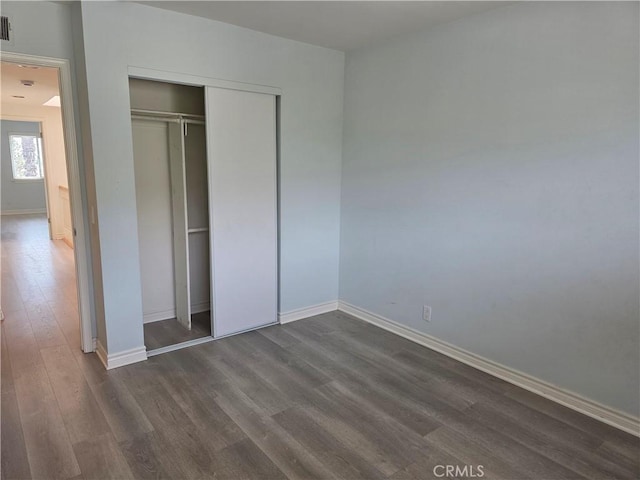 2937 Oakwood Ln, Torrance, CA 90505 - unfurnished bedroom featuring dark wood finished floors, baseboards, and a closet