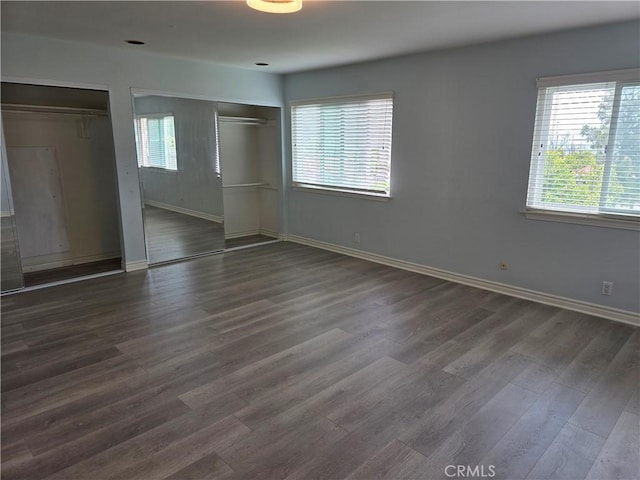 2937 Oakwood Ln, Torrance, CA 90505 - unfurnished bedroom with multiple windows, wood finished floors, multiple closets, and baseboards