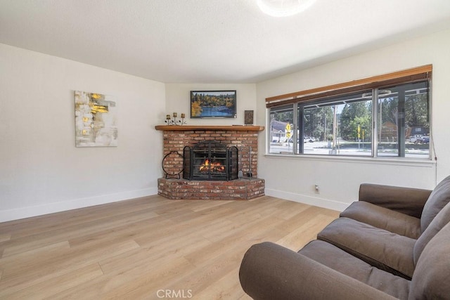 42692 Moonridge Rd, Big Bear Lake, CA 92315 - living room with wood finished floors, a brick fireplace, and baseboards