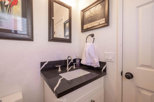 42692 Moonridge Rd, Big Bear Lake, CA 92315 - half bathroom with vanity, a textured wall, and toilet