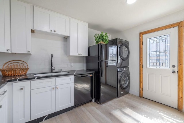 42692 Moonridge Rd, Big Bear Lake, CA 92315 - kitchen with black appliances, stacked washer and clothes dryer, a sink, dark countertops, and tasteful backsplash