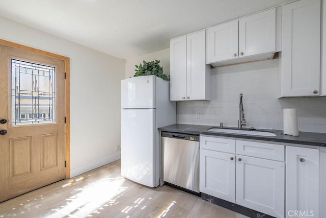 42692 Moonridge Rd, Big Bear Lake, CA 92315 - kitchen featuring stainless steel dishwasher, freestanding refrigerator, a sink, backsplash, and dark countertops