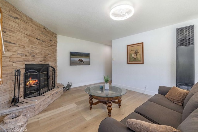 42692 Moonridge Rd, Big Bear Lake, CA 92315 - living area with a heating unit, light wood finished floors, baseboards, and a fireplace