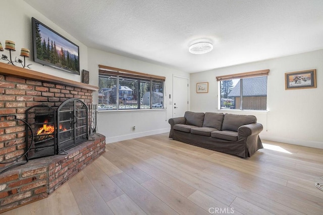 42692 Moonridge Rd, Big Bear Lake, CA 92315 - living area featuring a brick fireplace, baseboards, wood finished floors, and a textured ceiling
