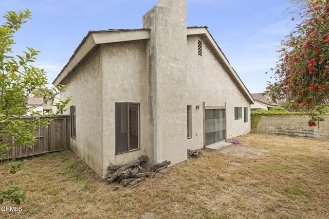201 Village Rd, Port Hueneme, CA 93041 - rear view of house with stucco siding and a chimney