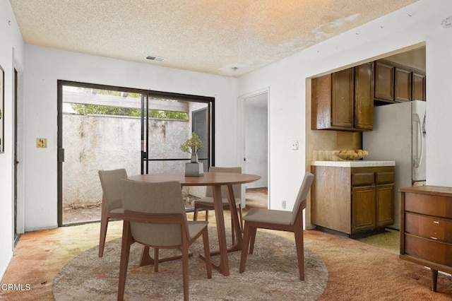 201 Village Rd, Port Hueneme, CA 93041 - dining area featuring light colored carpet and a textured ceiling