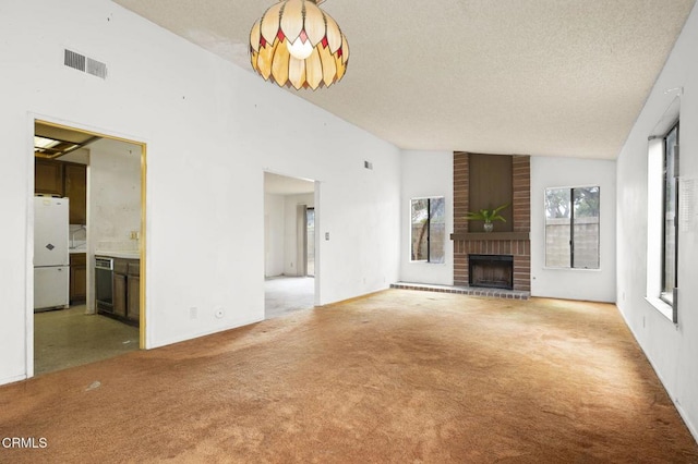 201 Village Rd, Port Hueneme, CA 93041 - unfurnished living room with carpet, a fireplace, lofted ceiling, and a textured ceiling