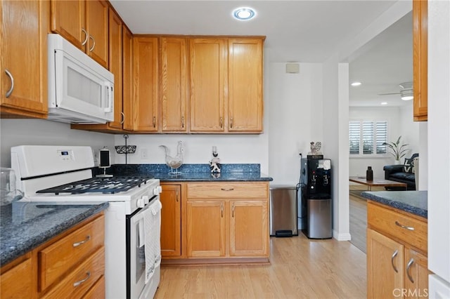 1630 247th Pl, Harbor City, CA 90710 - kitchen featuring white appliances, light wood finished floors, dark stone countertops, recessed lighting, and brown cabinetry
