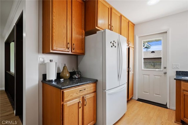 1630 247th Pl, Harbor City, CA 90710 - kitchen with freestanding refrigerator, light wood finished floors, brown cabinets, dark stone countertops, and recessed lighting