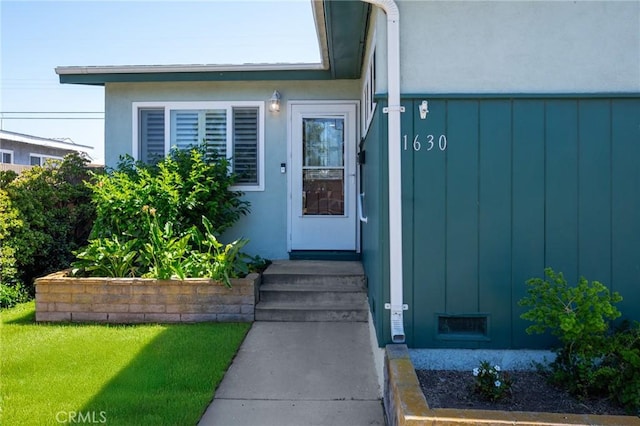 1630 247th Pl, Harbor City, CA 90710 - property entrance with board and batten siding, stucco siding, and a yard