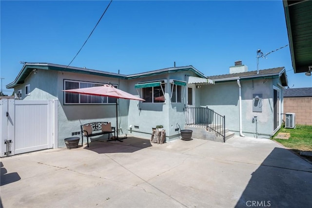 1630 247th Pl, Harbor City, CA 90710 - rear view of house with a patio area, stucco siding, a chimney, and central AC unit
