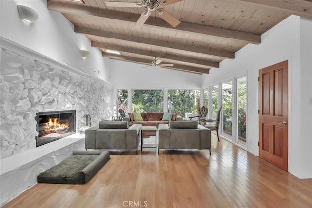 9466 Hidden Valley Pl, Beverly Hills, CA 90210 - living area with wood ceiling, ceiling fan, a stone fireplace, and wood finished floors