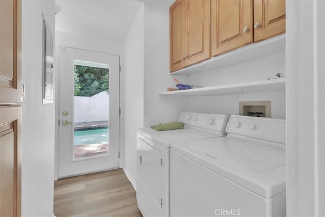 9466 Hidden Valley Pl, Beverly Hills, CA 90210 - washroom with cabinet space, washer and dryer, and light wood-type flooring