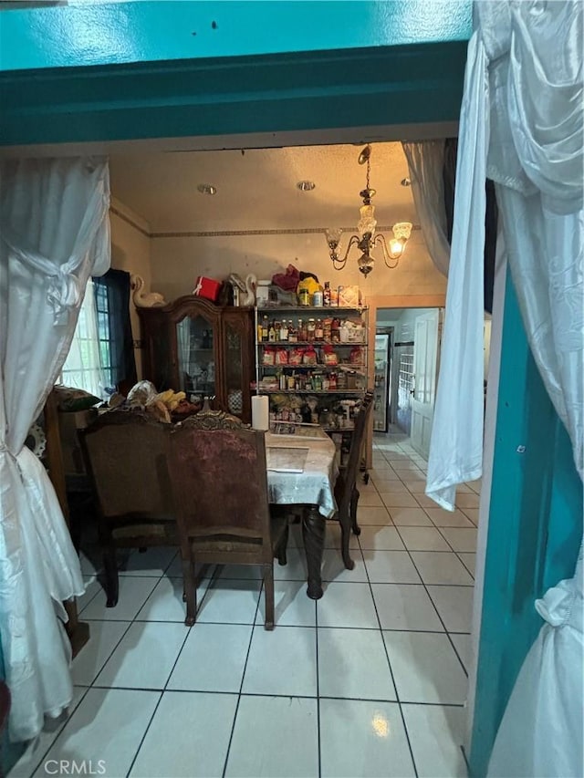 223 E 28th St, Los Angeles, CA 90011 - dining space with a chandelier and light tile patterned floors