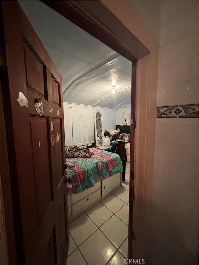 223 E 28th St, Los Angeles, CA 90011 - bedroom featuring light tile patterned floors and tile walls