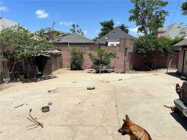 223 E 28th St, Los Angeles, CA 90011 - fenced backyard with a patio area