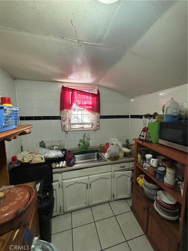 223 E 28th St, Los Angeles, CA 90011 - kitchen with a sink, light tile patterned floors, and lofted ceiling