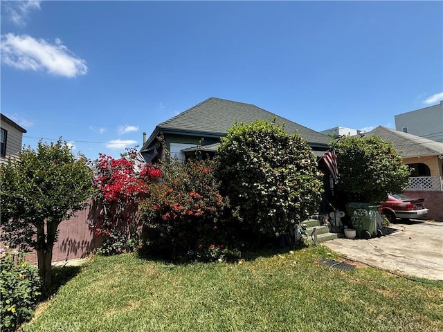 223 E 28th St, Los Angeles, CA 90011 - view of side of home featuring a shingled roof and a patio