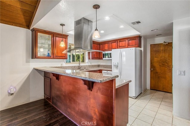 4256 Mockingbird Ln, Banning, CA 92220 - kitchen featuring white fridge with ice dispenser, island range hood, a peninsula, light stone countertops, and glass insert cabinets