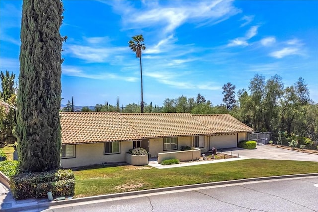 4256 Mockingbird Ln, Banning, CA 92220 - ranch-style home featuring a tile roof, stucco siding, driveway, and an attached garage