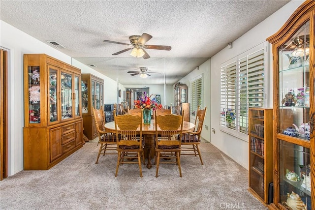 4256 Mockingbird Ln, Banning, CA 92220 - dining space with a textured ceiling, carpet, and ceiling fan