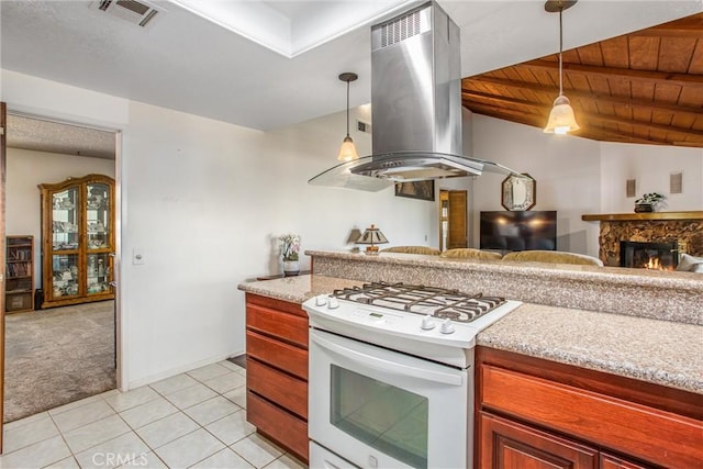 4256 Mockingbird Ln, Banning, CA 92220 - kitchen with gas range gas stove, island range hood, open floor plan, light carpet, and hanging light fixtures